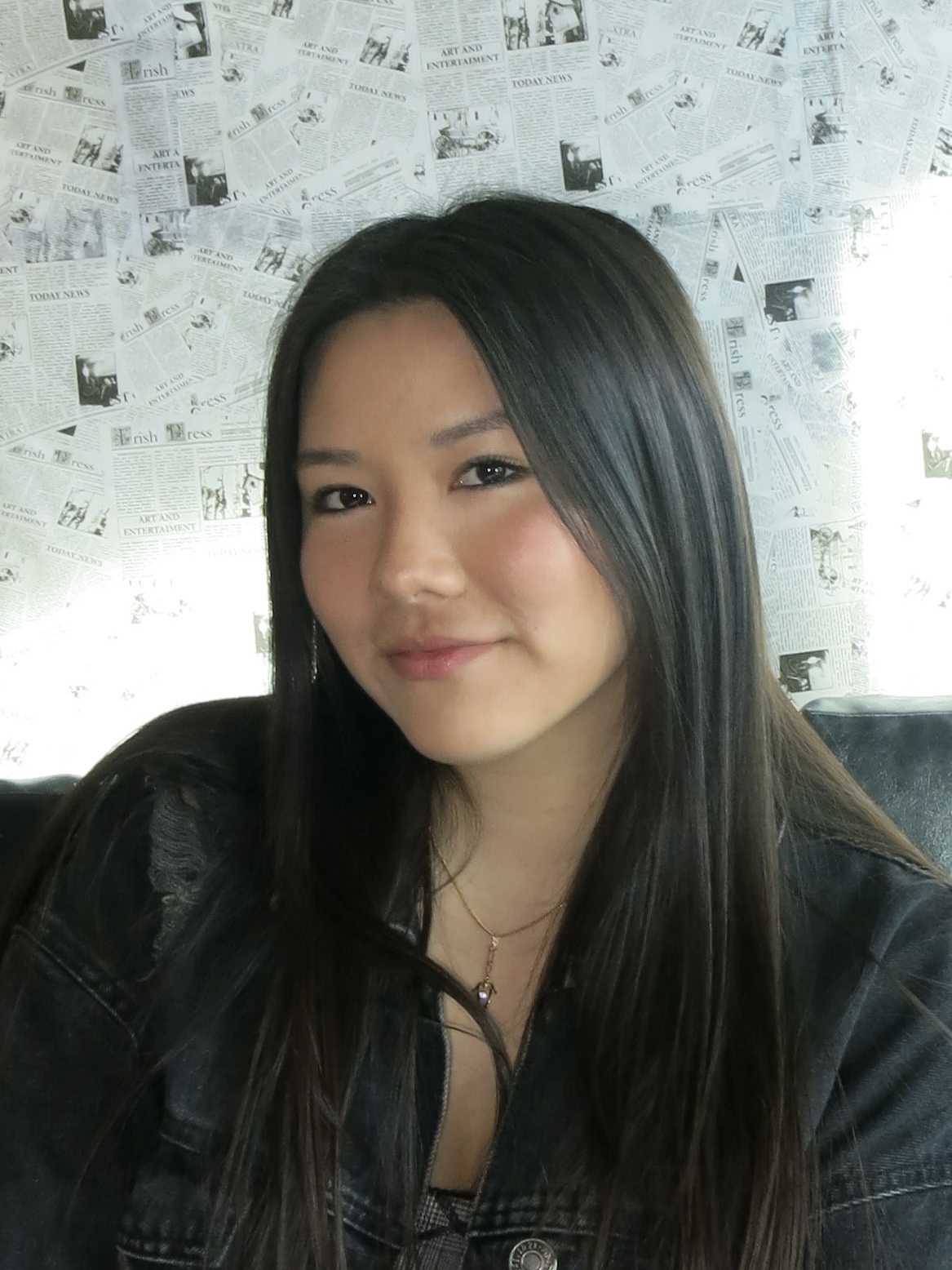 Vivian looks at the camera wearing a black jacket.